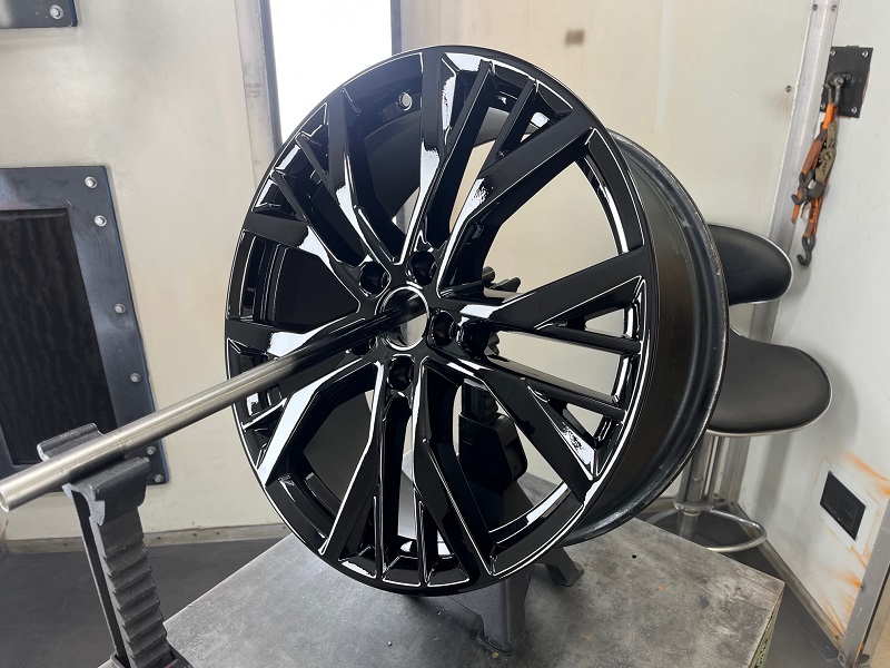 singlw alloy rim in black powder coating in painting booth